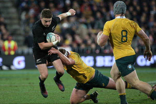 Beauden Barrett against Australia with Michael Hooper making the tackle and David Pocock watching on during the 2016 Rugby Championship game