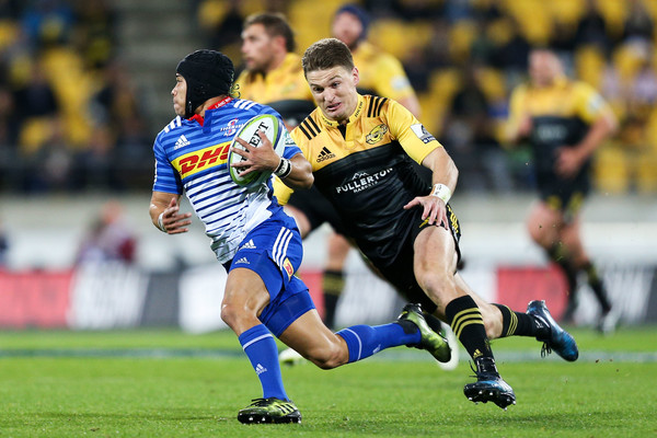 The Hurricanes playmaker Beauden Barrett is trying to tackle the Stormers winger Cheslin Kolbe at Westpac Stadium in Wellington in 2017